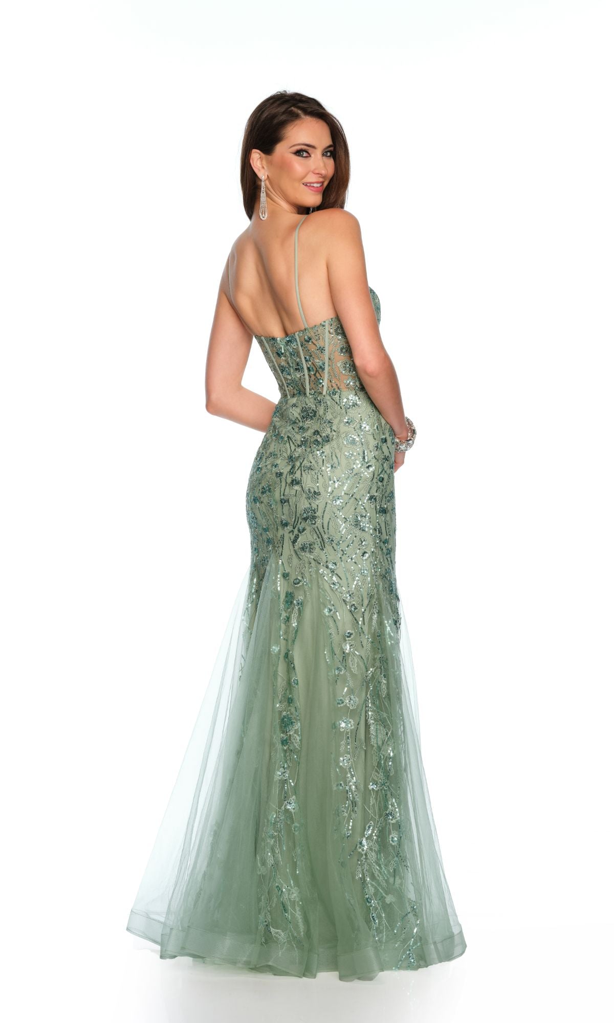A woman wearing the Dave & Johnny Long Prom Dress 11658, a light green sequin mermaid gown with thin straps and a v-neckline, stands looking over her shoulder against a white background.